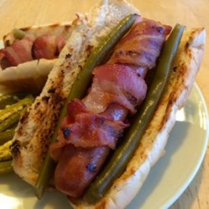 Photo of a hot dog wrapped with bacon and Bolder Beans